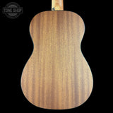 Back view of a wooden acoustic guitar with 'Tone Shop' logo.