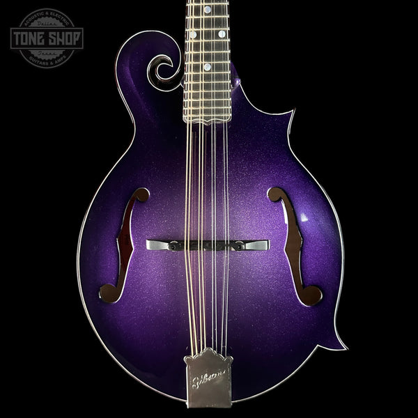 A purple glitter-finish Gibson mandolin shown from the front against a black background, with a Tone Shop watermark in the upper left corner.