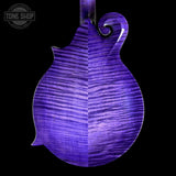 A close-up of a mandolin's back, showcasing a vibrant purple flamed maple top with prominent grain patterns, set against a solid black background.
