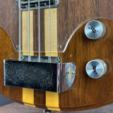 Close-up of a wooden electric guitar with a focus on the neck and body.