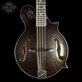A close-up studio shot of a Gibson mandolin against a solid black background, featuring a dark brown glitter finish with gold sparkle, silver hardware, and a white Gibson logo on the bridge plate.