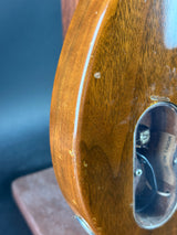 Close-up of a wooden object with a metal component on a dark background