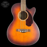 Acoustic guitar with a sunburst finish on a black background, featuring the Tone Shop logo.