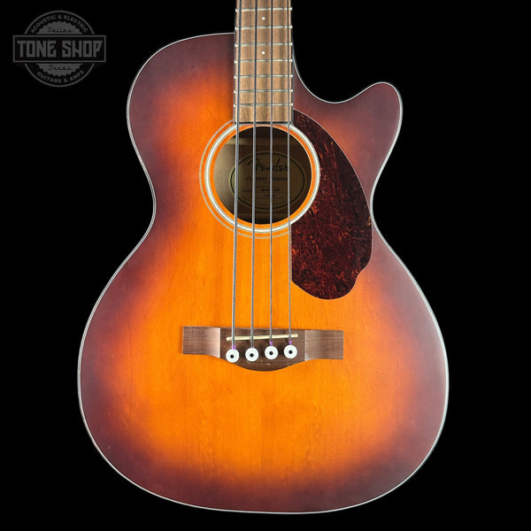 Acoustic guitar with a sunburst finish on a black background, featuring the Tone Shop logo.