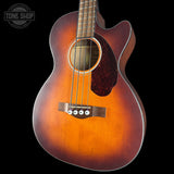Acoustic guitar with a sunburst finish on a black background, featuring the Tone Shop logo.