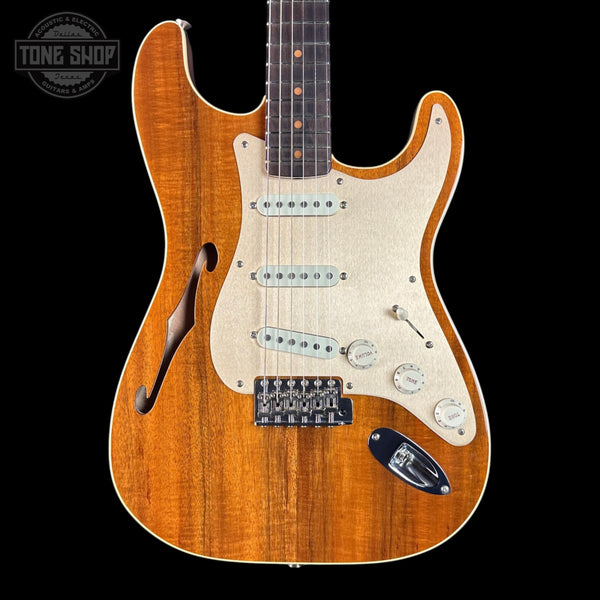 Electric guitar with a sunburst finish on a black background, featuring the Tone Shop logo.