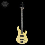 Electric bass guitar with a cream finish on a black background, featuring the Tone Shop logo.