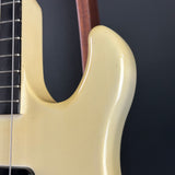 Close-up of a guitar's neck and headstock against a dark background