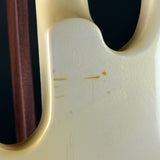 Close-up of a guitar neck and headstock with visible wear.