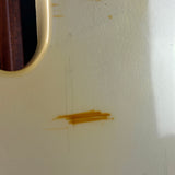 Close-up of a guitar with a brown stain on the body