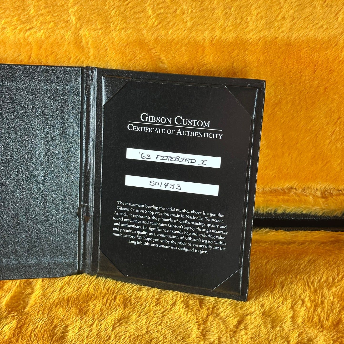 Gibson Custom Certificate of Authenticity on a yellow textured surface