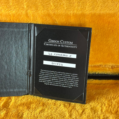 Gibson Custom Certificate of Authenticity on a yellow textured surface