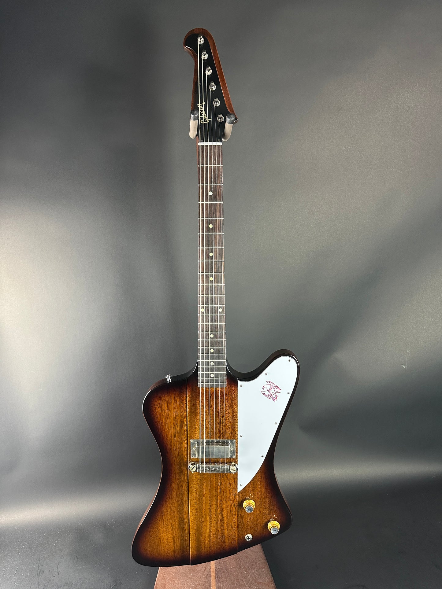 Guitar with a brown and white design on a gray background