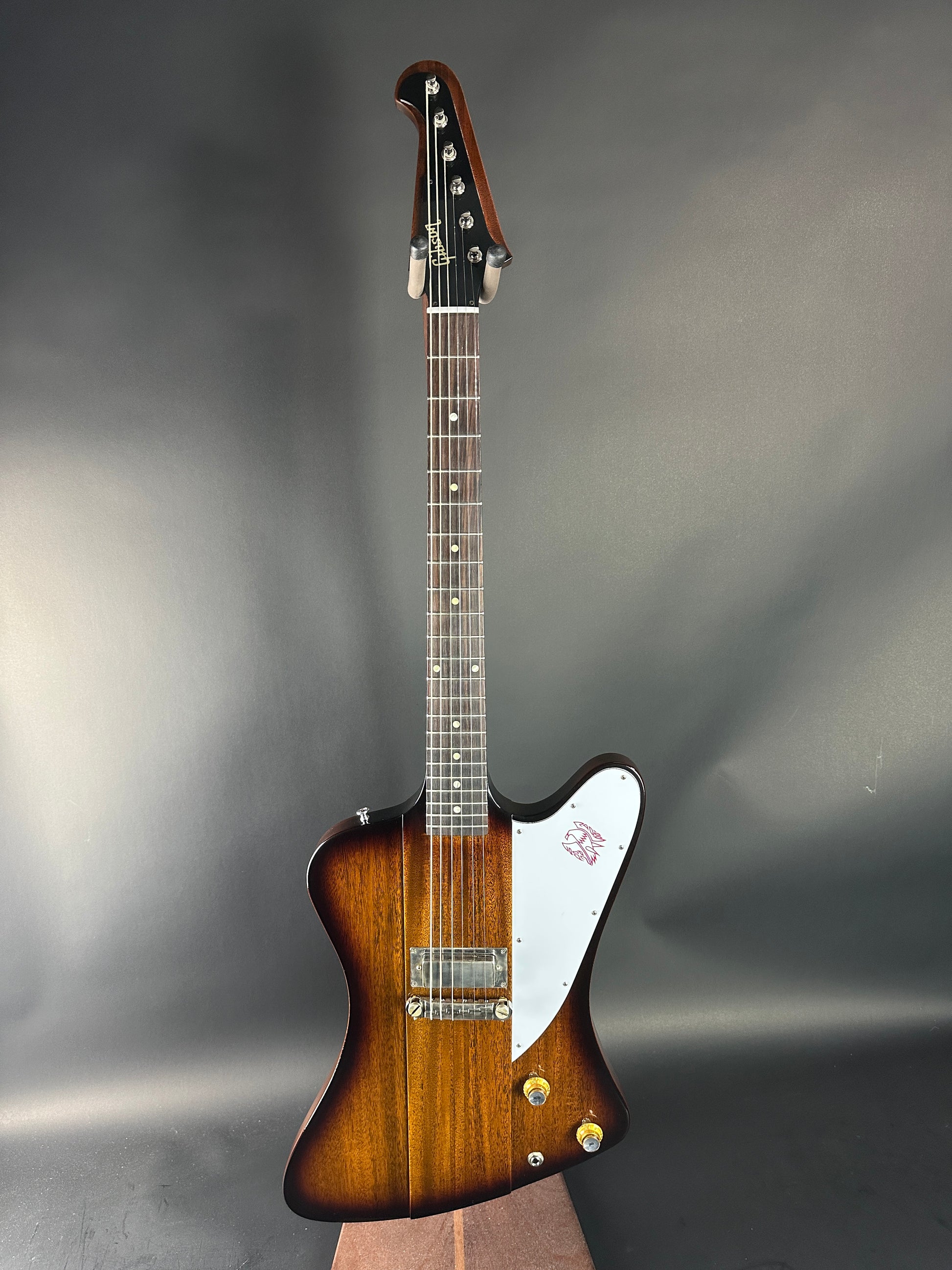 Guitar with a brown and white design on a gray background