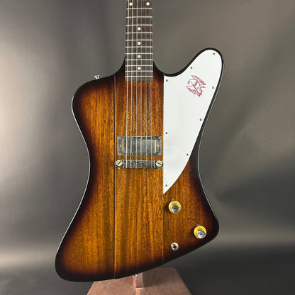 Gibson guitar with a sunburst finish on a gray background