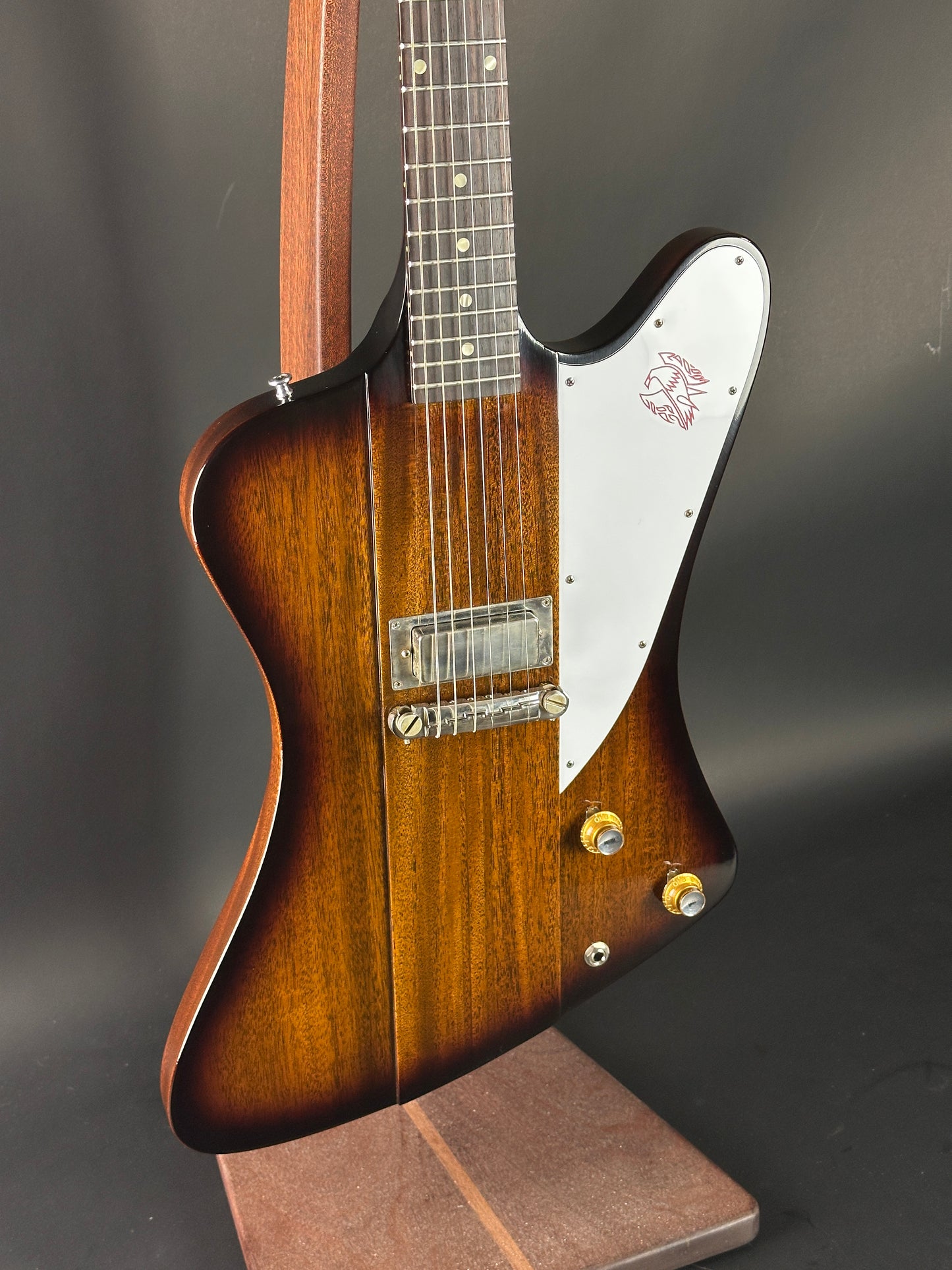 Electric guitar with a sunburst finish on a dark background