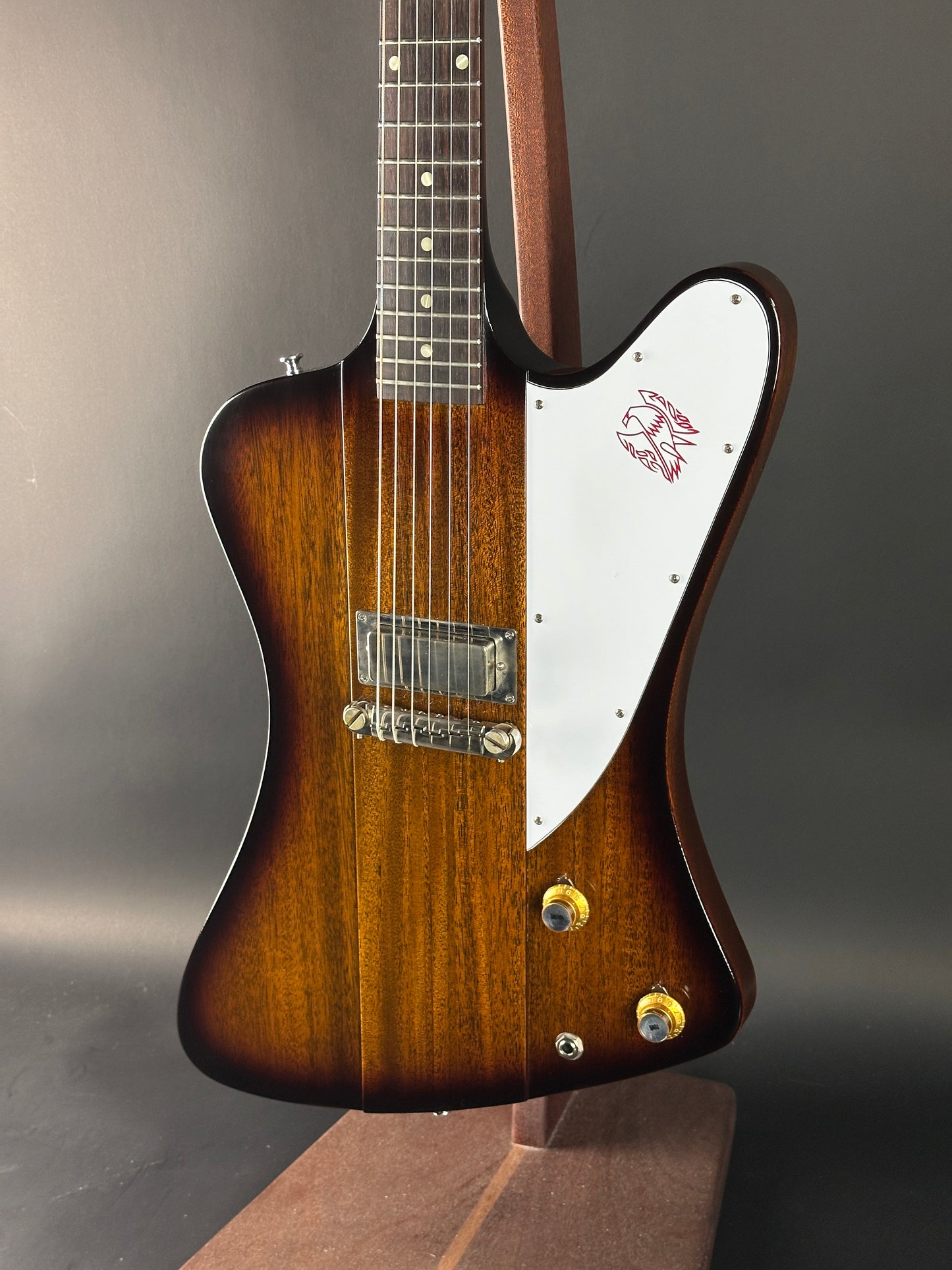 Guitar with a brown and white body on a gray background