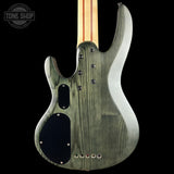 Back view of a green electric guitar with a black pickguard on a black background, featuring 'Tone Shop' branding.