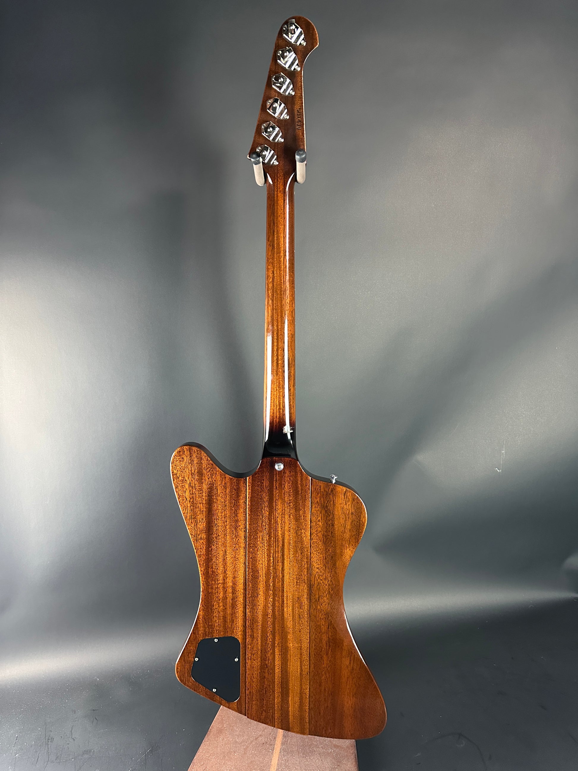 Wooden electric guitar body on a gray background
