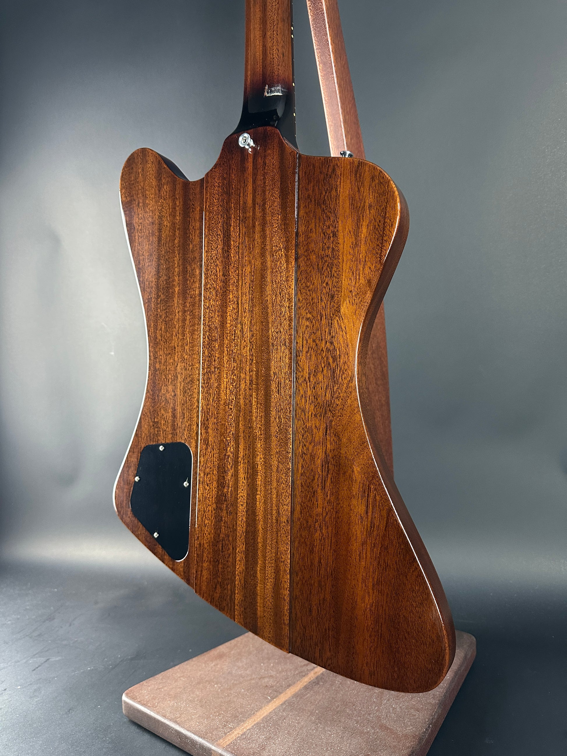 Wooden guitar body on a gray background
