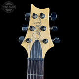 Guitar headstock with brand logo on a black background