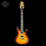 Electric guitar with a sunburst finish on a black background, featuring the Tone Shop logo.
