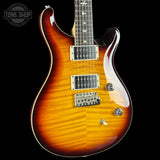 Electric guitar with a sunburst finish on a black background, featuring the Tone Shop logo.