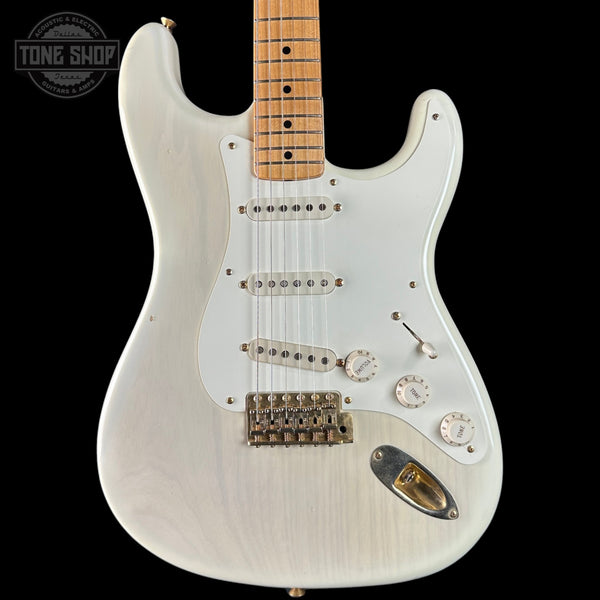 White electric guitar with a black background