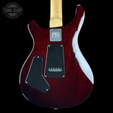 Red electric guitar with a visible brand logo on a black background