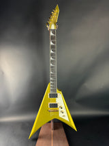 Yellow electric guitar with a unique design on a dark background