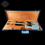 Electric guitar in an open case with 'Tone Shop' logo.