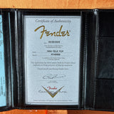 Fender certificate of authenticity in a black leather holder
