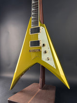 Yellow electric guitar with a unique design on a dark background