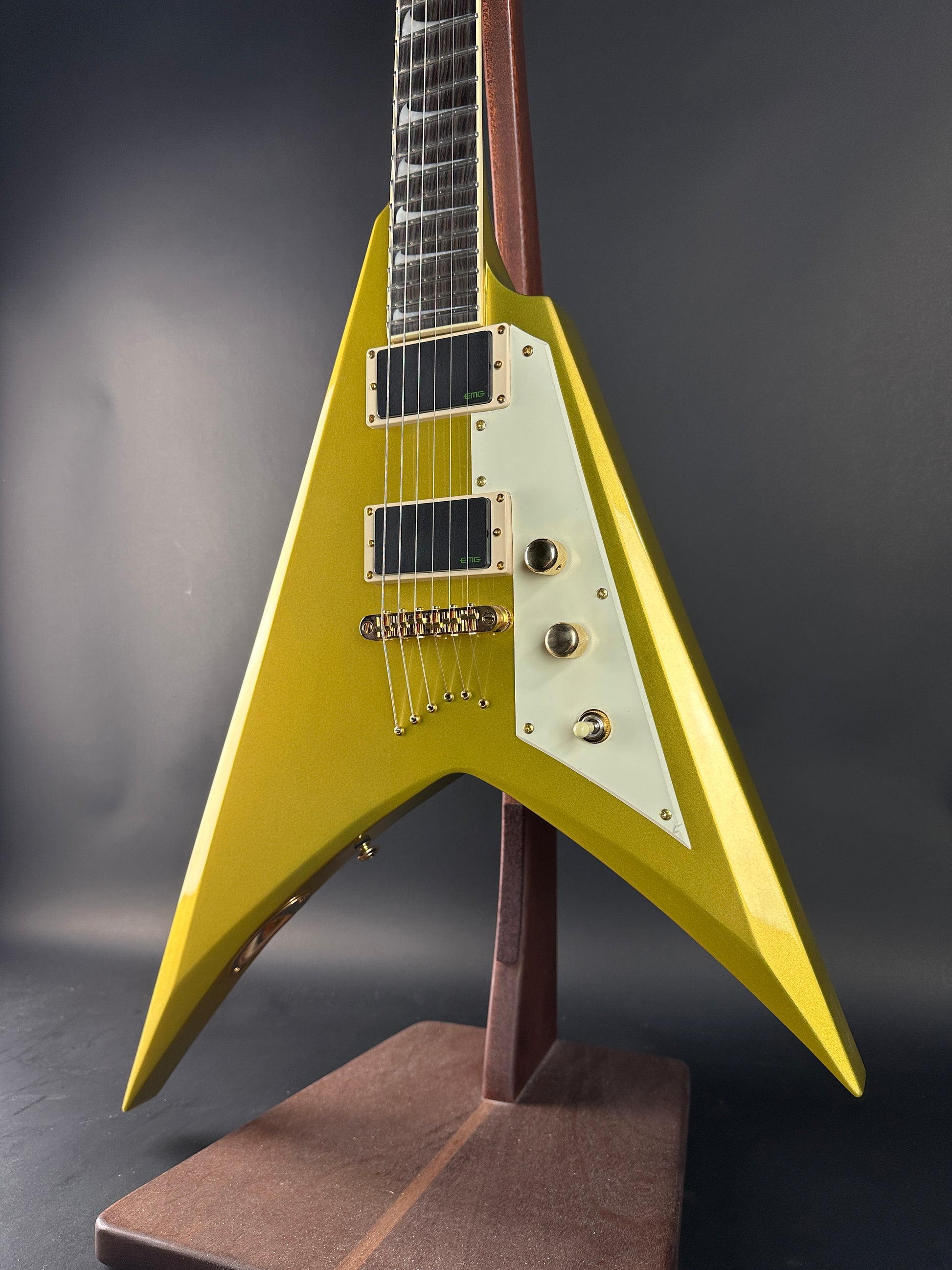 Yellow electric guitar with a unique design on a dark background