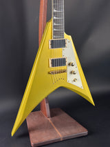 Yellow electric guitar with a unique design on a dark background