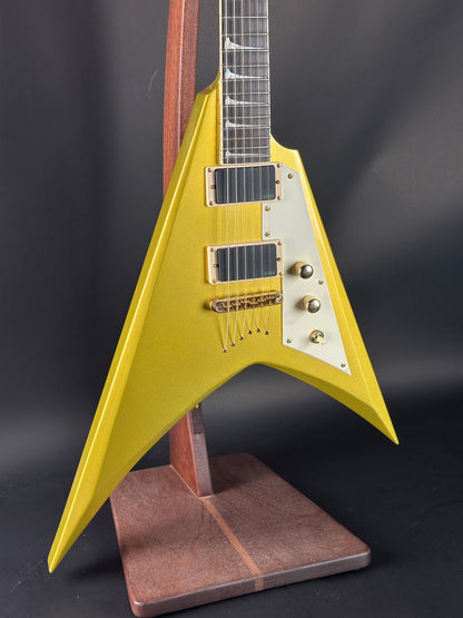 Yellow electric guitar with a unique design on a dark background