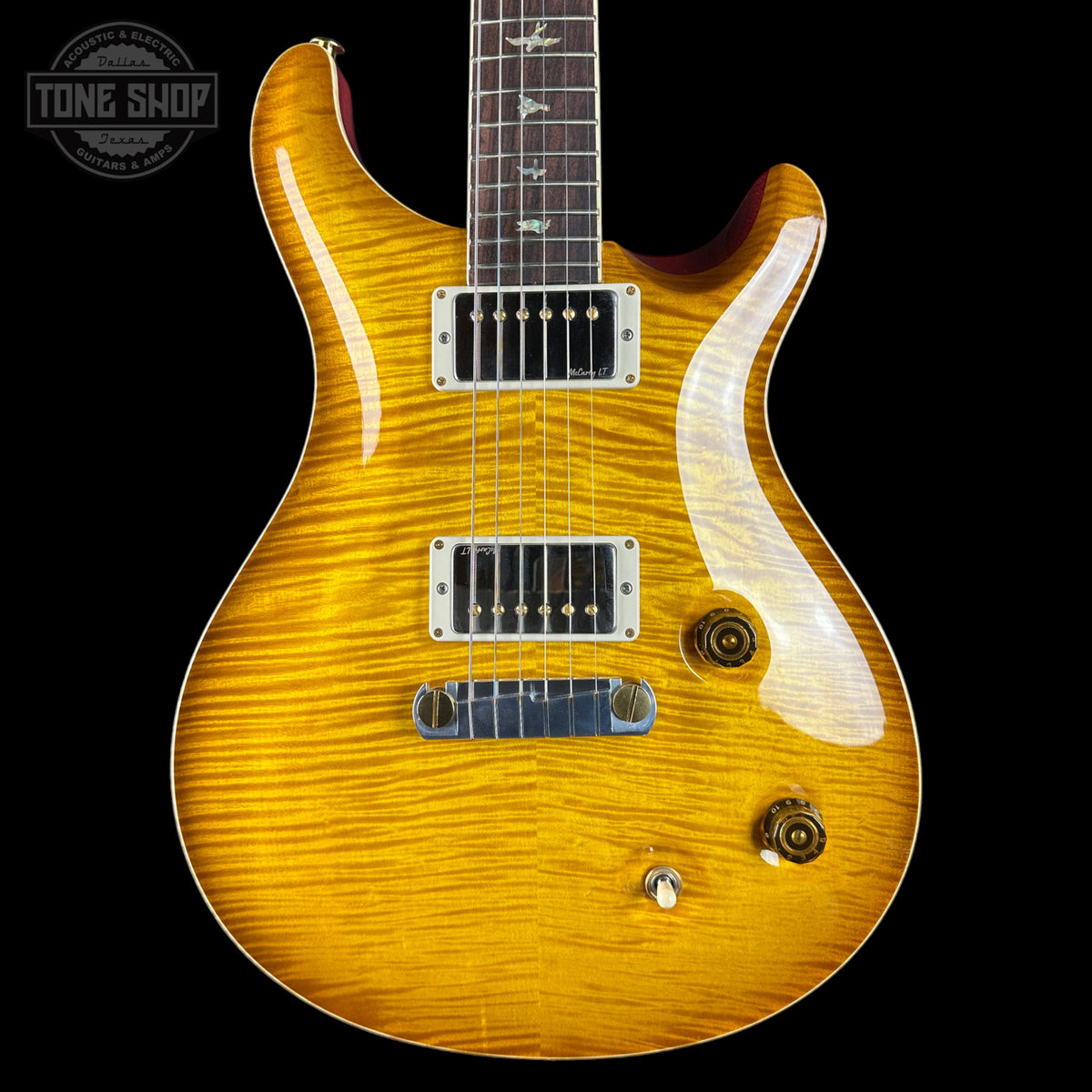 Wooden electric guitar with a visible brand logo on a black background
