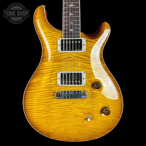 Wooden electric guitar with a visible brand logo on a black background