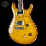 Electric guitar with a sunburst finish on a black background, featuring the Tone Shop logo.