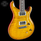Electric guitar with a sunburst finish on a black background, featuring the Tone Shop logo.