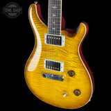 Electric guitar with a sunburst finish on a black background, featuring the Tone Shop logo.
