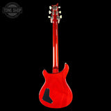 Red electric guitar on a black background with 'Tone Shop' logo.