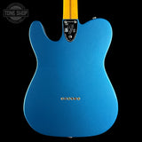 The back of a blue Fender Telecaster electric guitar with a yellow maple neck, shown against a solid black background. A Tone Shop watermark is visible in the top-left corner.