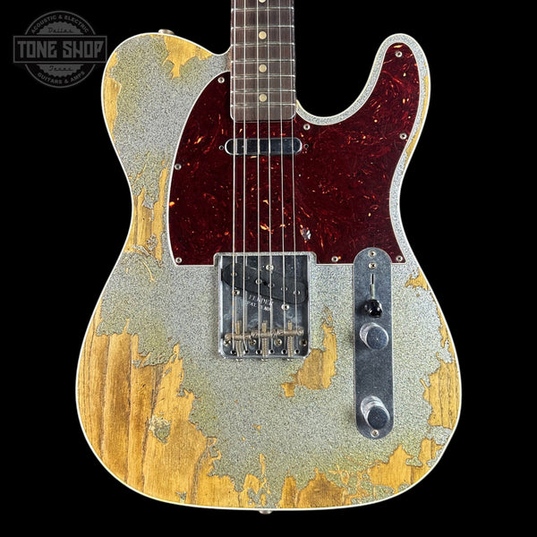 Guitar with distressed finish on a black background, featuring the Tone Shop logo.