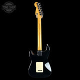 Black electric guitar with a blonde neck on a black background, featuring 'Tone Shop' logo.