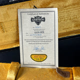 Certificate of Authenticity for a Gretsch guitar on a wooden surface