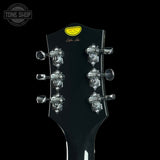 Guitar headstock with tuning pegs on a black background, featuring the 'Tone Shop' logo.
