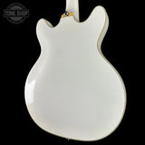 White electric guitar body on a black background with 'Tone Shop' logo.