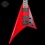 A red electric guitar with a black pickguard and black pickups, shown against a solid black background with a Tone Shop watermark in the top left corner.