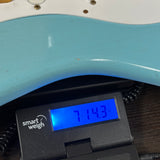 Used Fender Custom Shop 70th Anniversary 1954 Strat Journeyman Relic Daphne Blue on scale displaying weight.